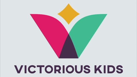 Victorious Kids logo with colorful geometric shapes - pink and green wings, yellow star, dark triangle, and text